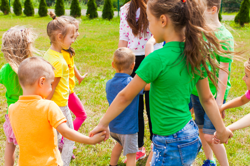 Children holding hands and standing in circle. Outdoor games in summer - Outdoor Activities for Grandma Camp