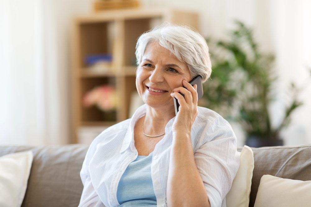 A grandmother talks on a cell phone - Back to School - The Grandkid Connection